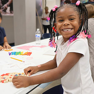 Young girl coloring and smiling